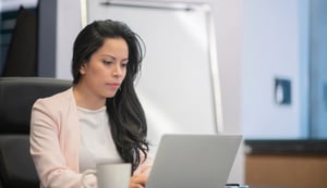 Latina working on a laptop