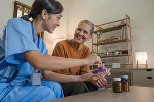 Asian caregiver nurse consulting with Caucasian about pills