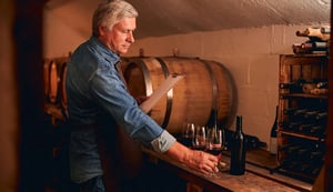 careful-winery-employee-making-descriptions-of-wine