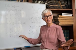 College Professor explaining Math at board