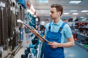 Employee choosing concrete drill in store