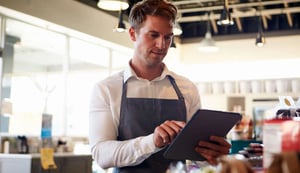 employee-in-delicatessen-checking-stock-with-digital