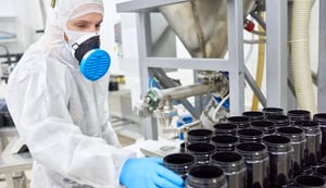 factory-employee-taking-plastic-jar-from-pile