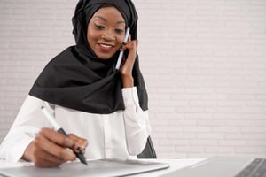 female-office-worker-talking-on-phone-writing-sm-2021-08-31-01-53-54-utc